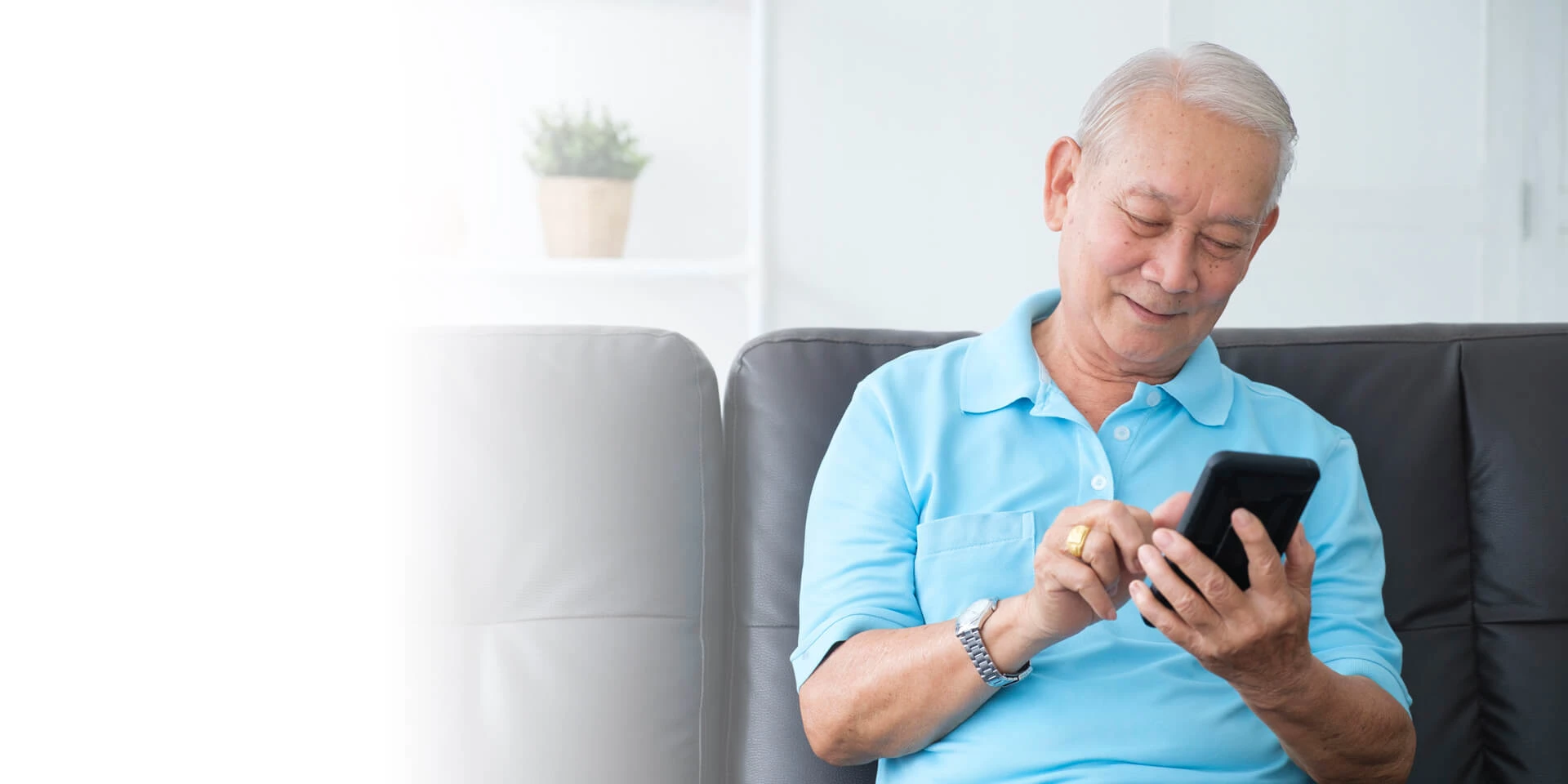 A man using his mobile device for touchtone banking